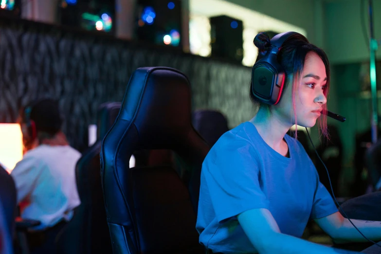 a woman wearing headphones sitting in front of a computer, trending on pexels, hurufiyya, e-sport style, profile image, jin shan and ross tran, pictured from the shoulders up