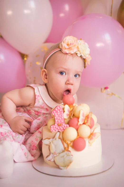 a baby girl sitting in front of a birthday cake, a portrait, pexels, baroque, party balloons, portrait image, unedited, headshot