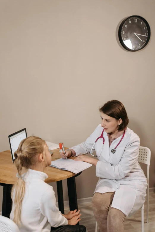 a woman sitting at a table talking to a little girl, the doctor, 15081959 21121991 01012000 4k, low quality photo, high quality product photo