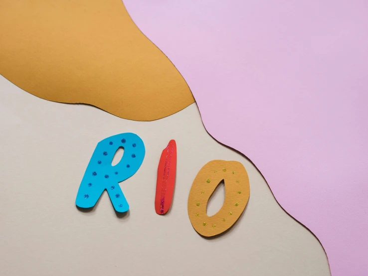 a piece of paper with the word rio written on it, an album cover, inspired by Jean Arp, trending on unsplash, made of clay, multi - coloured, kids, river island