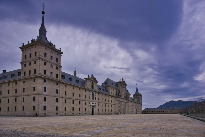 a large building with a clock tower on top of it, inspired by Pedro Álvarez Castelló, pexels contest winner, baroque, square, barracks, “wide shot, francisco de zurbaran