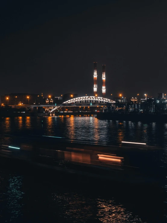 a large body of water with a bridge in the background, by Adam Szentpétery, pexels contest winner, happening, moscow, night time footage, promo image, telephoto long distance shot