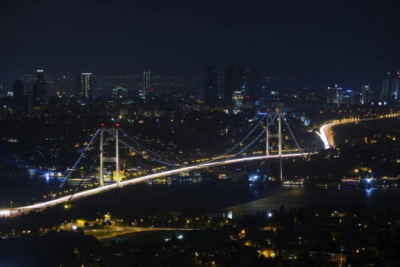 a view of a bridge over a city at night, by Yasar Vurdem, pexels contest winner, hurufiyya, istanbul, slide show, panorama, hd footage