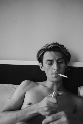 a man laying in bed with a cigarette in his mouth, a black and white photo, tumblr, johan liebert, flat chested, androgynous person, ash thorp khyzyl saleem