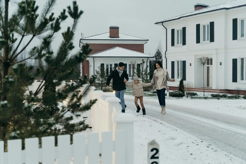 a couple of people that are walking in the snow, by Jaakko Mattila, pexels contest winner, hurufiyya, cottage town, happy family, background image