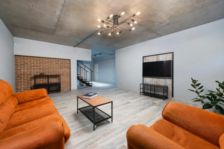 a living room filled with furniture and a fire place, inspired by Dennis Miller Bunker, unsplash, bauhaus, in a basement, simple ceiling, herringbone floor, shot with canon eoa 6 d mark ii