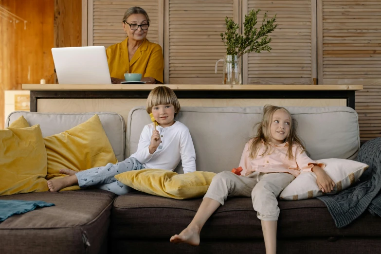 a couple of kids sitting on top of a couch, pexels, people at work, a blond, avatar image, husband wife and son