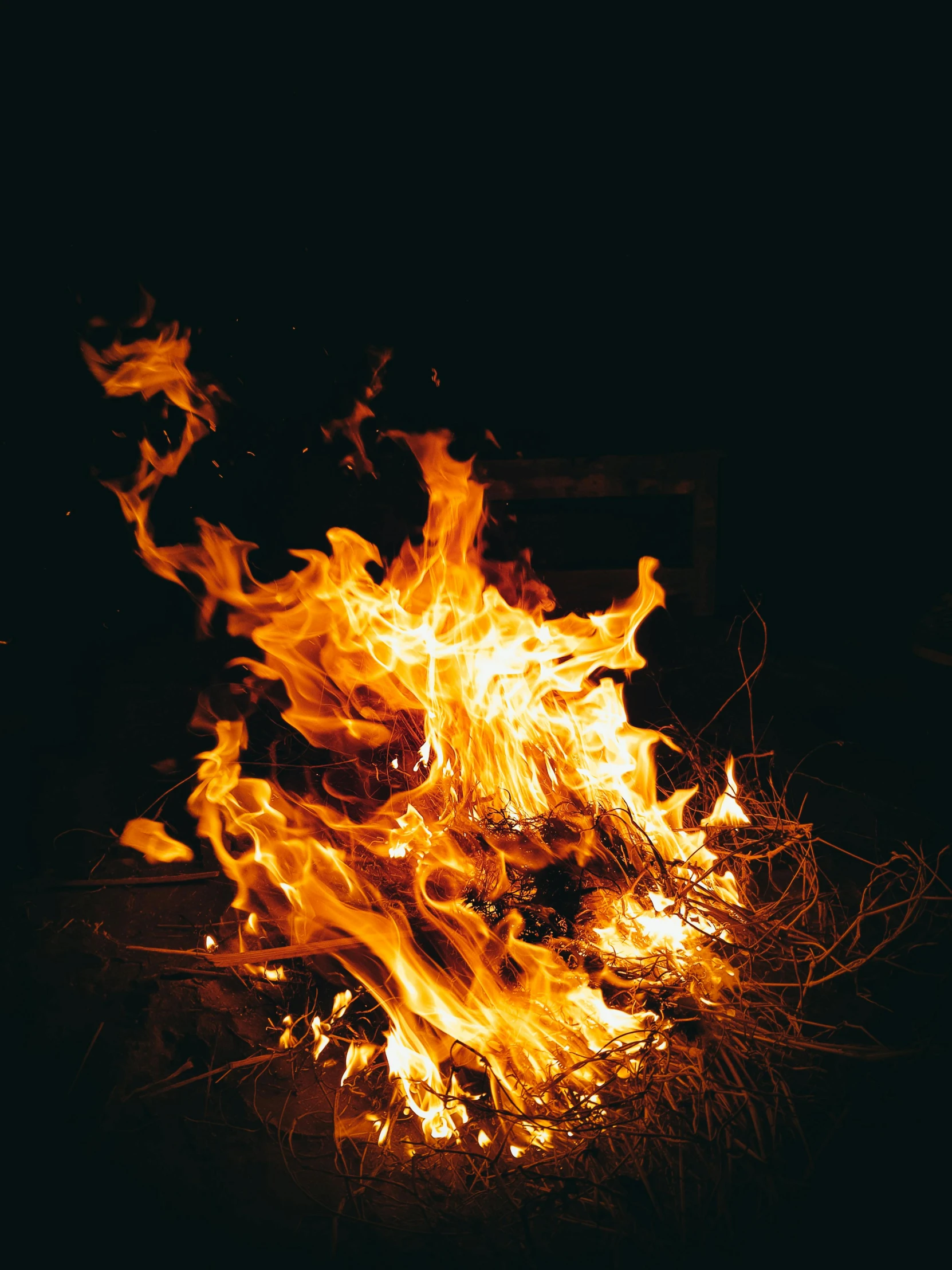 a close up of a fire in the dark, unsplash, multiple stories, a wooden, snapchat photo, profile image