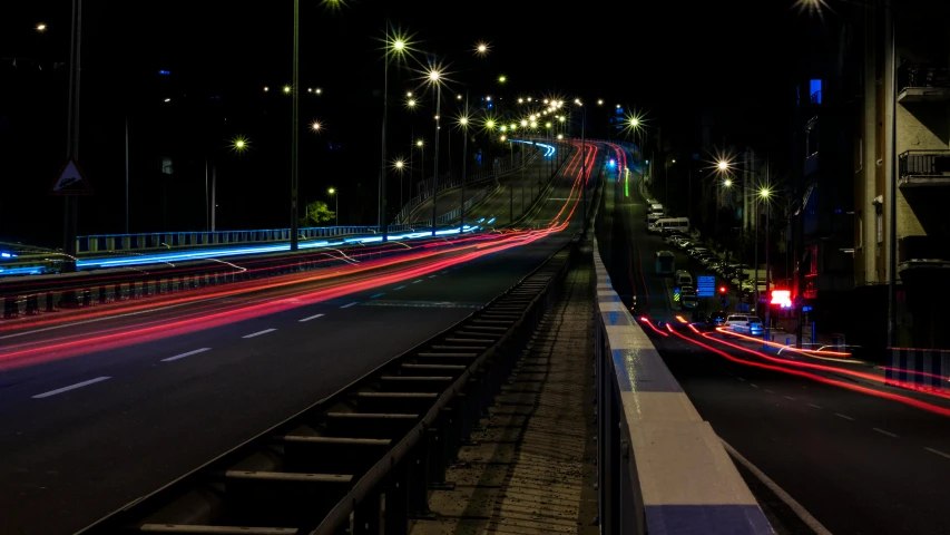 a city street filled with lots of traffic at night, an album cover, by Alejandro Obregón, unsplash, overpass, chromatic, street lamps, landscape photo