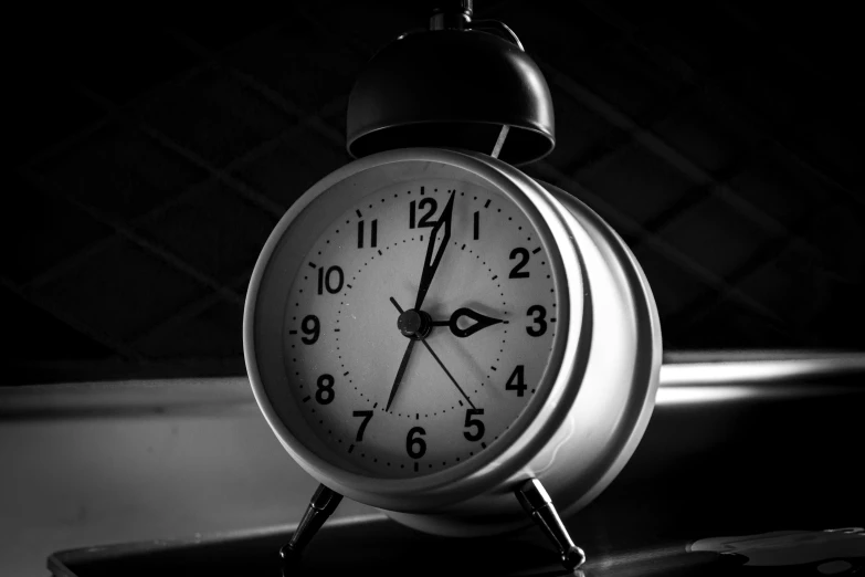 a black and white photo of an alarm clock, by Adam Chmielowski, pixabay, miscellaneous objects, night light, watch photo, photorealistic image