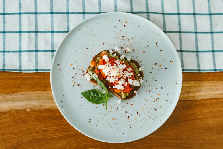 a close up of a plate of food on a table, by Emma Andijewska, pexels contest winner, one tomato slice, artoast8p, thumbnail, basil gogos