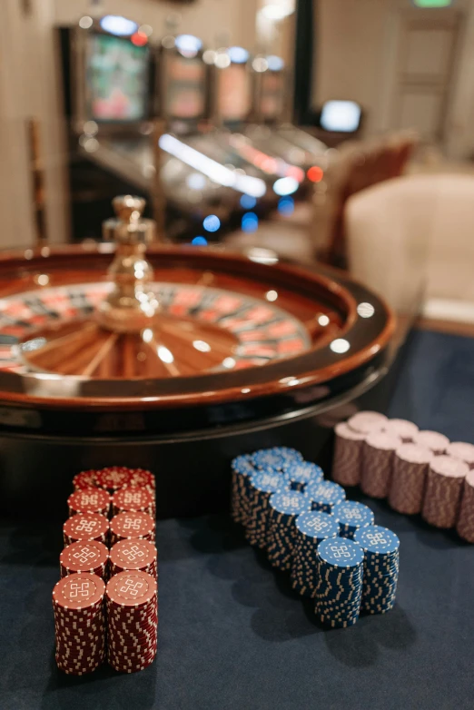 a casino roule and chips on a table, a picture, by Emma Andijewska, renaissance, thumbnail, indoor shot