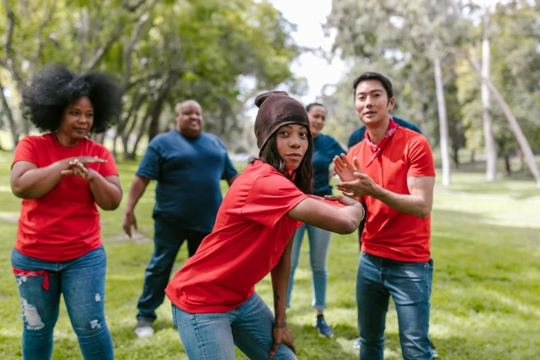 a group of people playing frisbee in a park, a portrait, pexels contest winner, wearing a red lumberjack shirt, avatar image, diverse, tai chi