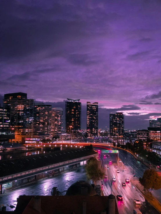 a view of a city at night from the top of a building, purple sky, night time photograph, cinematic paris, high res 8k