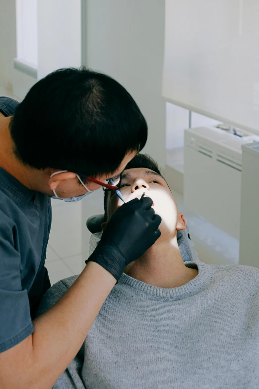 a man getting his teeth examined by a dentist, by Tooth Wu, instagram, slide show, korean, high angle, translucent