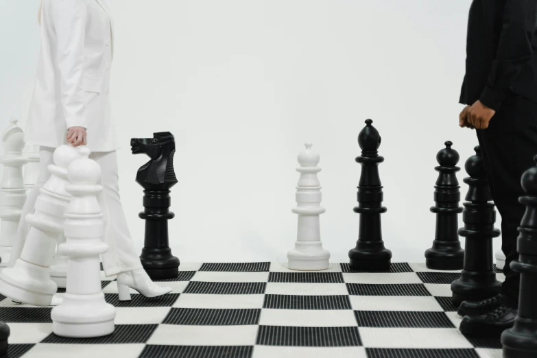 a man and a woman playing a game of chess, an album cover, by Carey Morris, pexels contest winner, hypermodernism, white plastic armour, zentai suit, miniature product photo, trending on dezeen