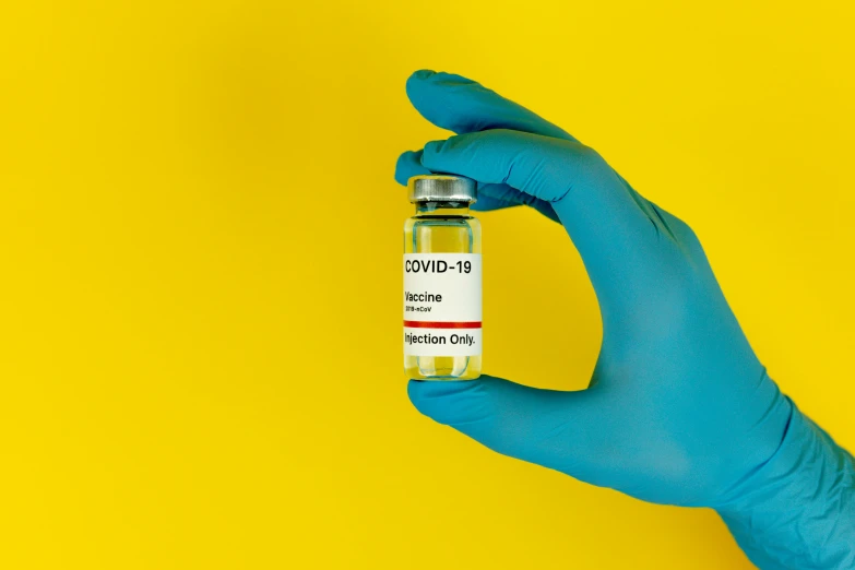 a person in a blue glove holding a vial, verdadism, on a yellow canva, 2263539546], instagram post, no blur