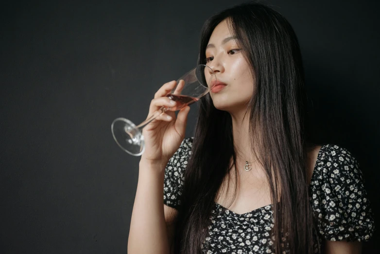 a woman is drinking a glass of wine, a portrait, pexels contest winner, half asian, black, various posed, mid 2 0's female