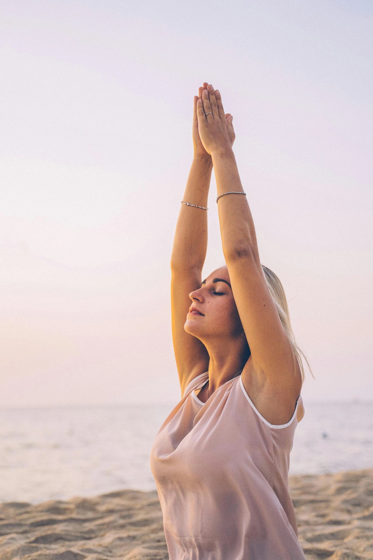 a woman is doing yoga on the beach, unsplash, renaissance, raised hand, digitally remastered, morning glow, transparent