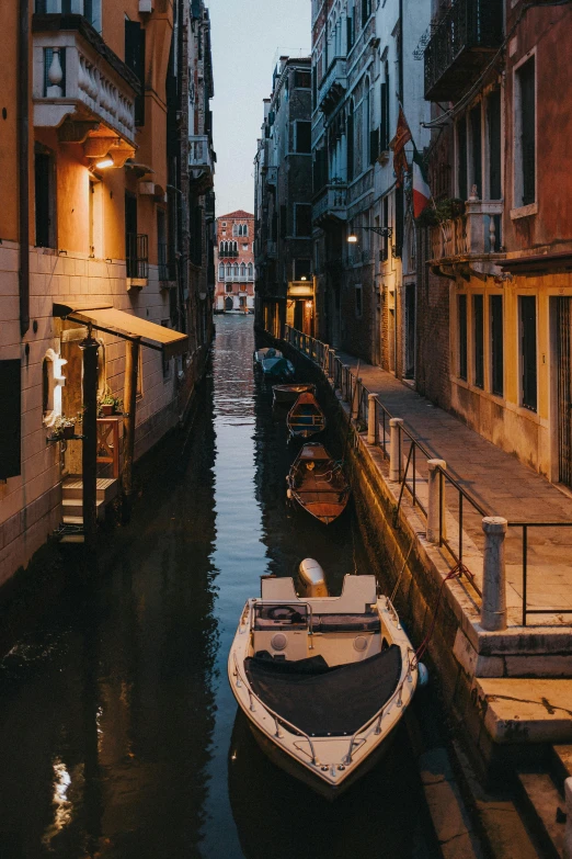 a boat that is sitting in the water, pexels contest winner, renaissance, narrow and winding cozy streets, early evening, 2022 photograph, payne's grey and venetian red