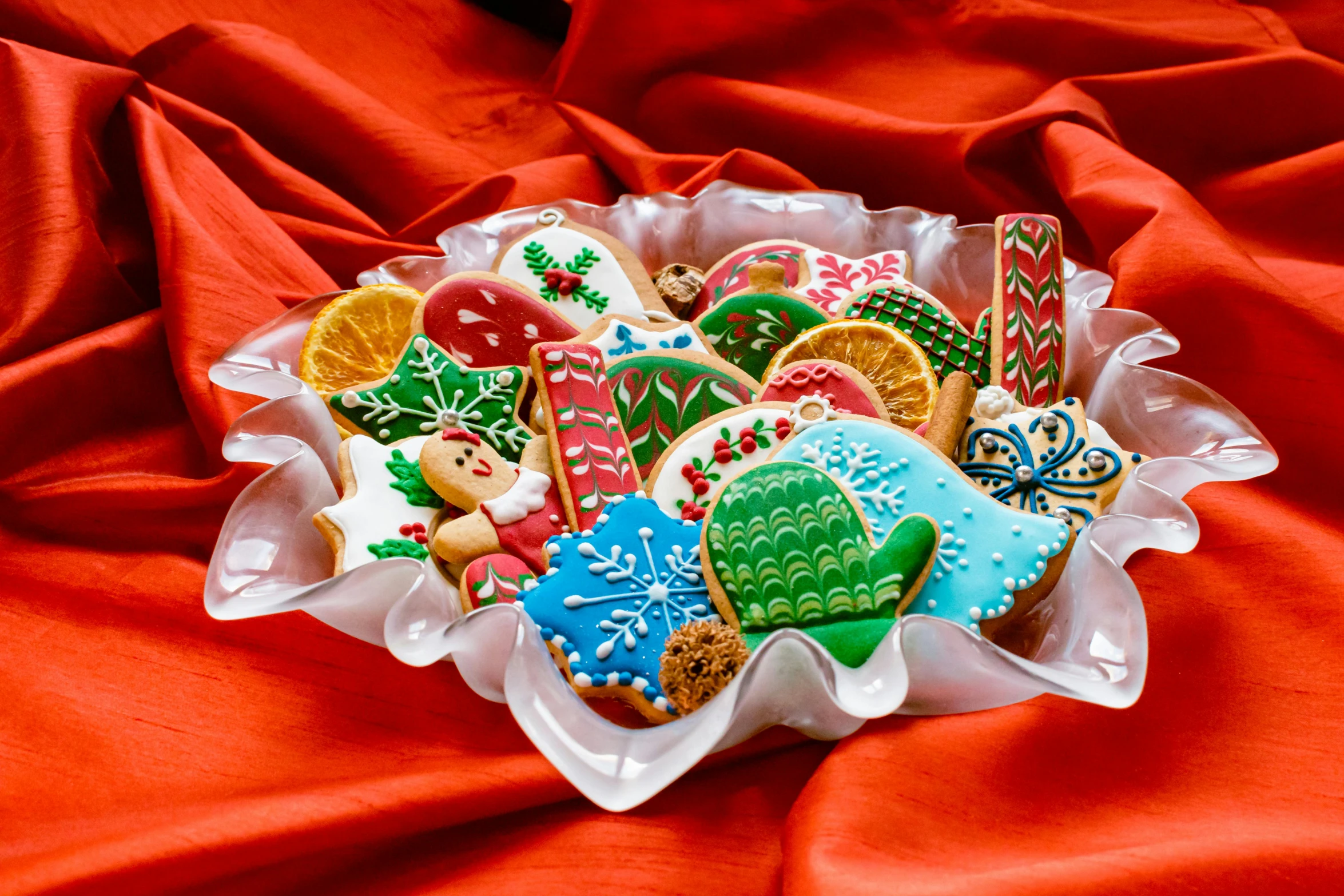 a close up of a plate of cookies on a red cloth, by Nancy Graves, shutterstock contest winner, naive art, decorated ornaments, shot for pottery magazine, colorful”, retro style ”