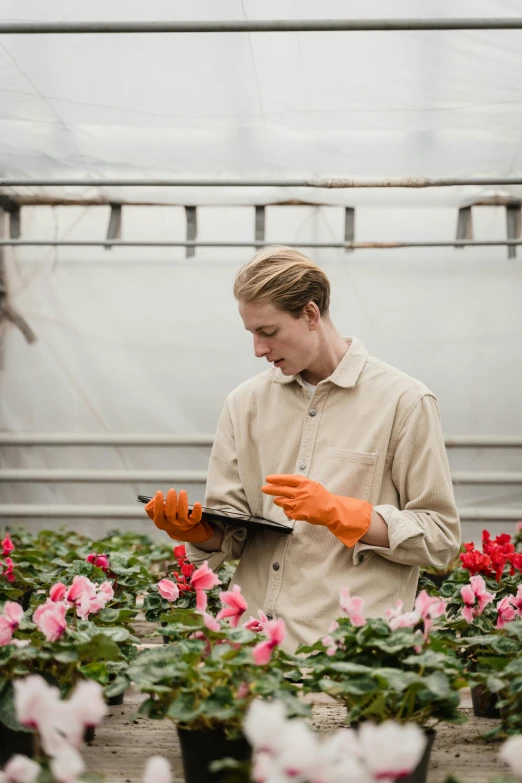 a man reading a book in a greenhouse, a portrait, unsplash, renaissance, flight suit and gloves, inspect in inventory image, blooming, carrying a tray