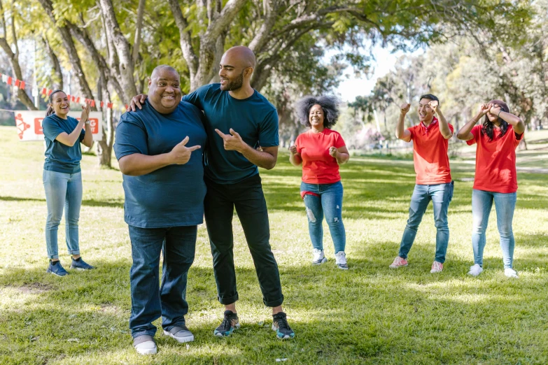 a group of people standing on top of a lush green field, plus-sized, at a park, avatar image, red and blue garments