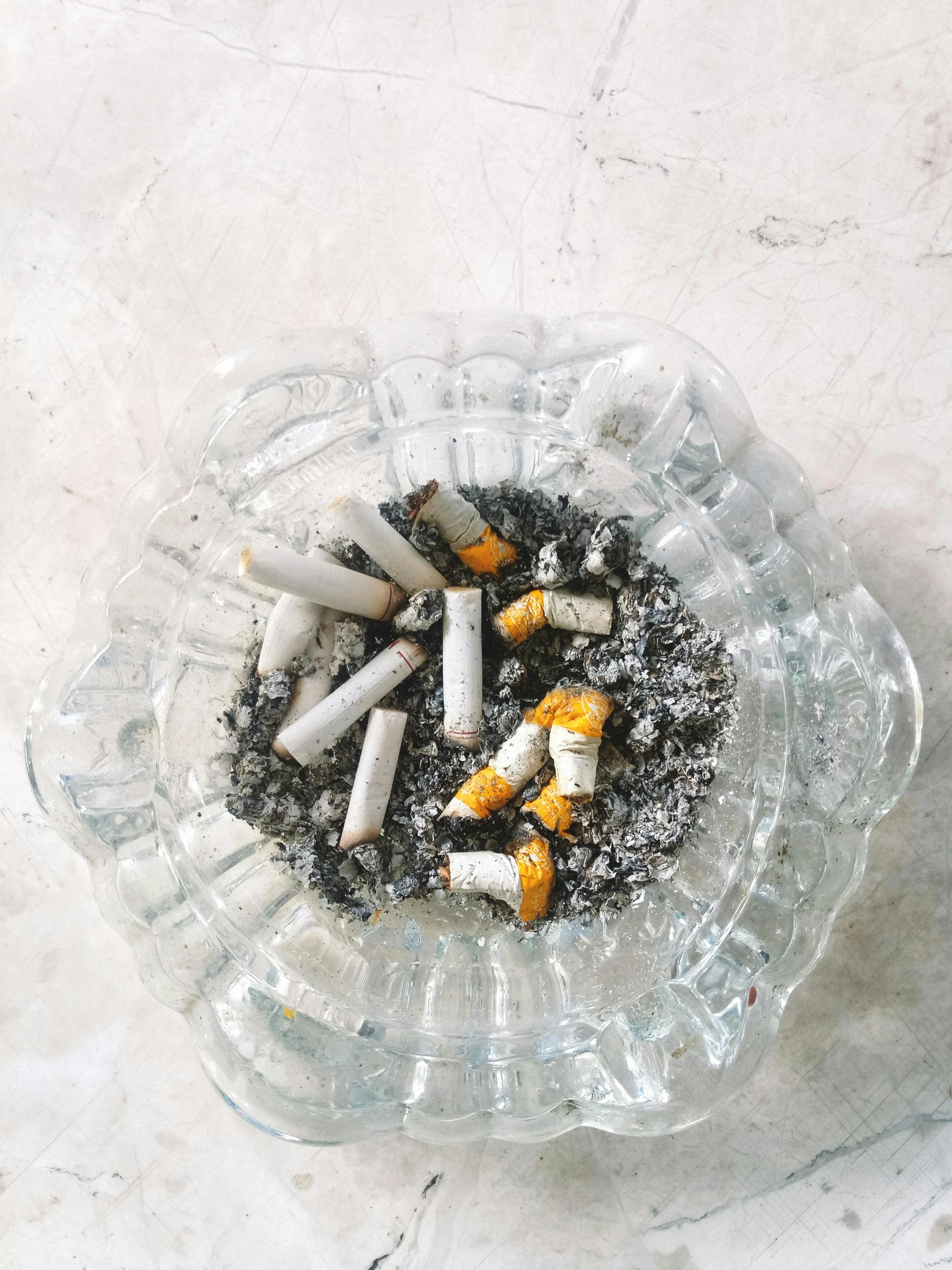 a glass ashtray with cigarettes in it, inspired by William Harnett, trending on unsplash, visual art, ilustration, 2 0 0 0 s, high transparency, instagram story