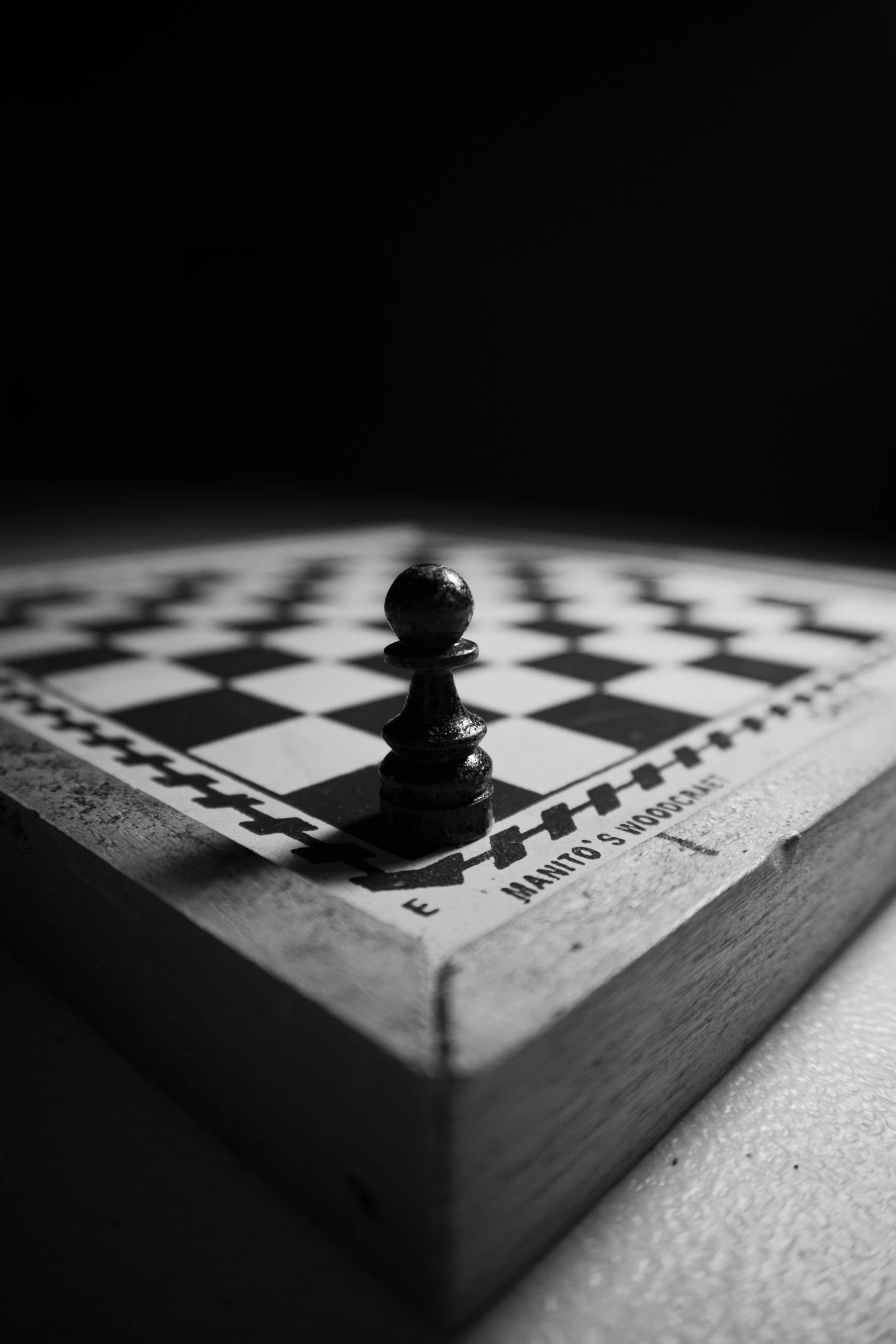 a black and white photo of a chess board, unsplash, 'lone dark figure'!!, intercrossed, \'the end, playing board games