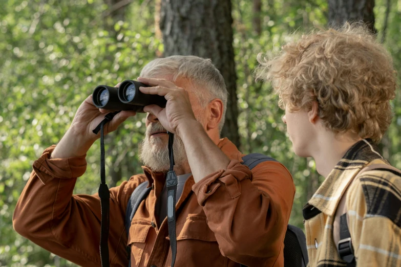 a man and a boy looking through binoculars, pexels contest winner, symbolism, tawny frogmouth, avatar image, older male, medium distance shot