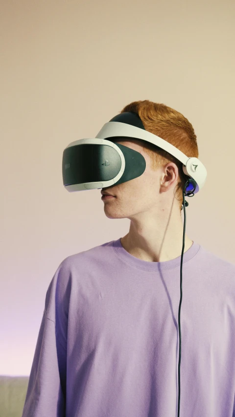 a man in a purple shirt wearing a virtual reality headset, by Carey Morris, unsplash, hypermodernism, portrait of a teen robot, taken with sony alpha 9, dezeen, wearing gaming headset