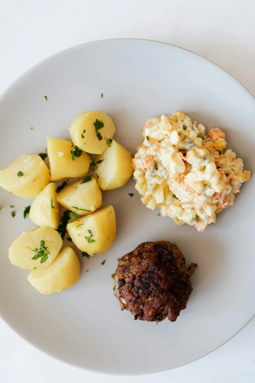 a white plate topped with potatoes and meatballs, by Emil Bisttram, unsplash, dau-al-set, nordic summer, mac and cheese, salad, humus