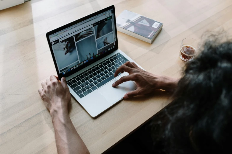 a person sitting at a table with a laptop, pexels contest winner, official screenshot, multiple stories, bottom angle, maintenance photo