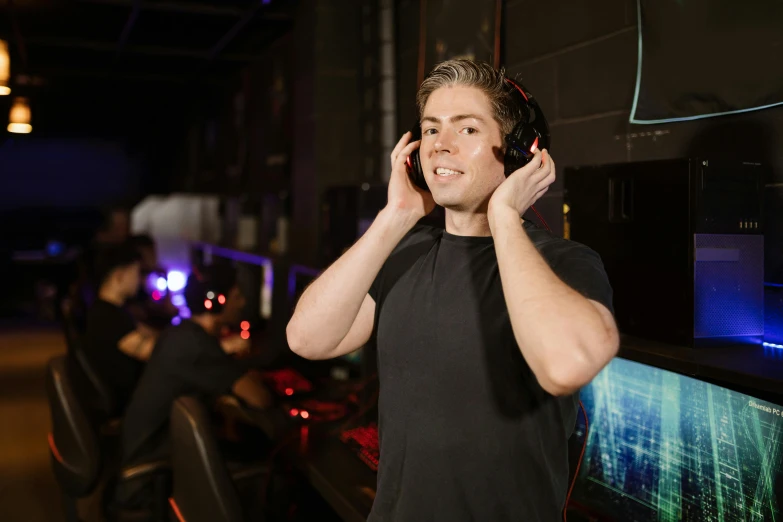 a man in a black shirt talking on a cell phone, wearing gaming headset, lachlan bailey, celebration, high quality image