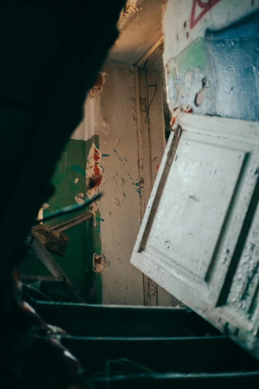 a person walking up a flight of stairs, by Elsa Bleda, happening, inside a haunted destroyed house, open door, high angle close up shot, an escape room in a small