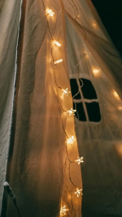 a tent is lit up with fairy lights, inspired by Cerith Wyn Evans, pexels contest winner, light and space, detail shot, instagram story, top down shot, bright daylight indoor photo