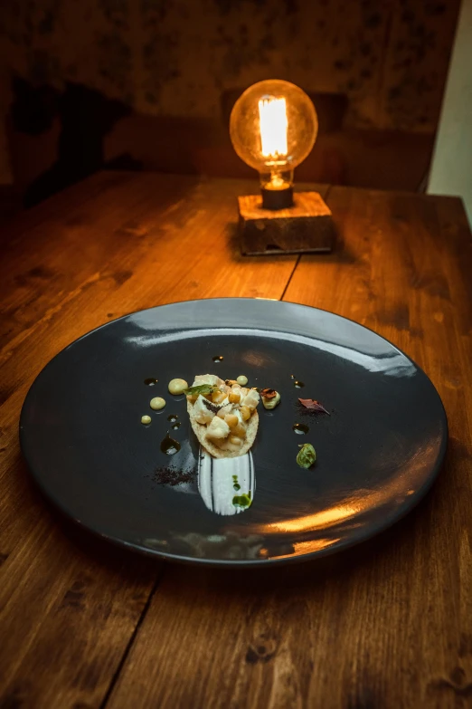 a plate of food sitting on top of a wooden table, inspired by Barthélemy Menn, award winning dark lighting, barnacle, individual, aspic