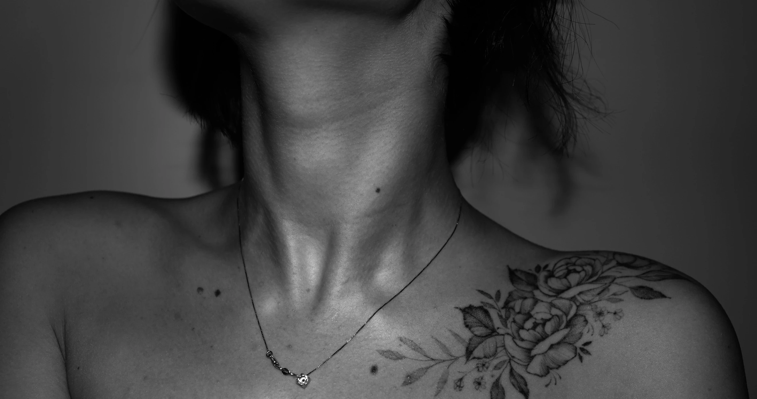 a woman with a tattoo on her chest, by Emma Andijewska, collar on neck, vascularity, minimalist, bloom