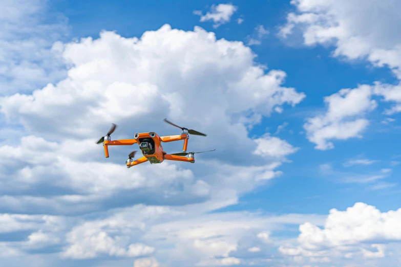 a small orange drone flying through a cloudy sky, unsplash, figuration libre, orange and blue sky, flying vehicles, slide show, taken in the early 2020s