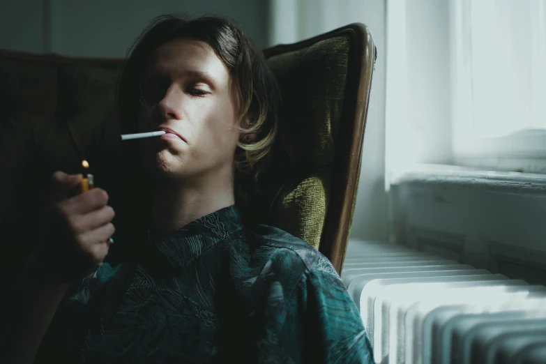 a man sitting in a chair with a cigarette in his mouth, by Elsa Bleda, pexels contest winner, hyperrealism, yung lean, orelsan, moody : : wes anderson, a still of an ethereal