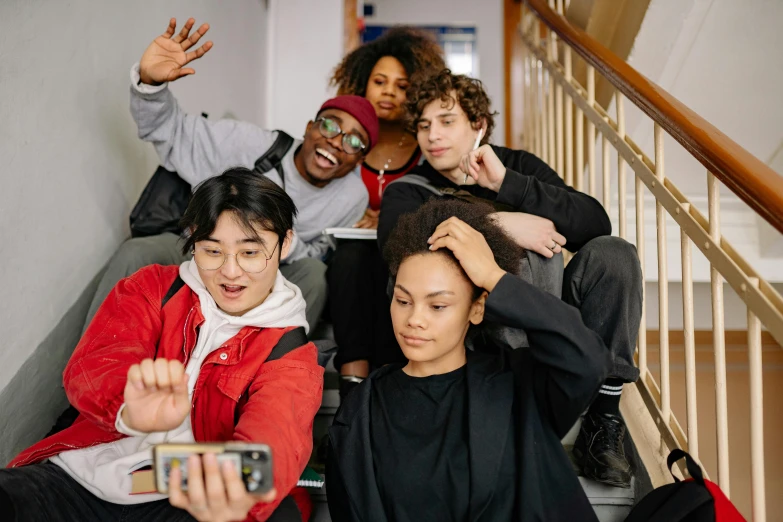 a group of people sitting on a set of stairs, trending on pexels, happening, taking a selfie, black teenage boy, charli bowater and artgeem, fzd school of design