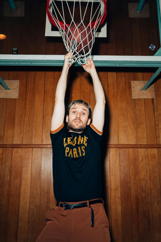 a man holding a basketball hoop above his head, an album cover, by Lee Gatch, dribble, happening, charlie day, épaule devant pose, mac miller, portrait photo