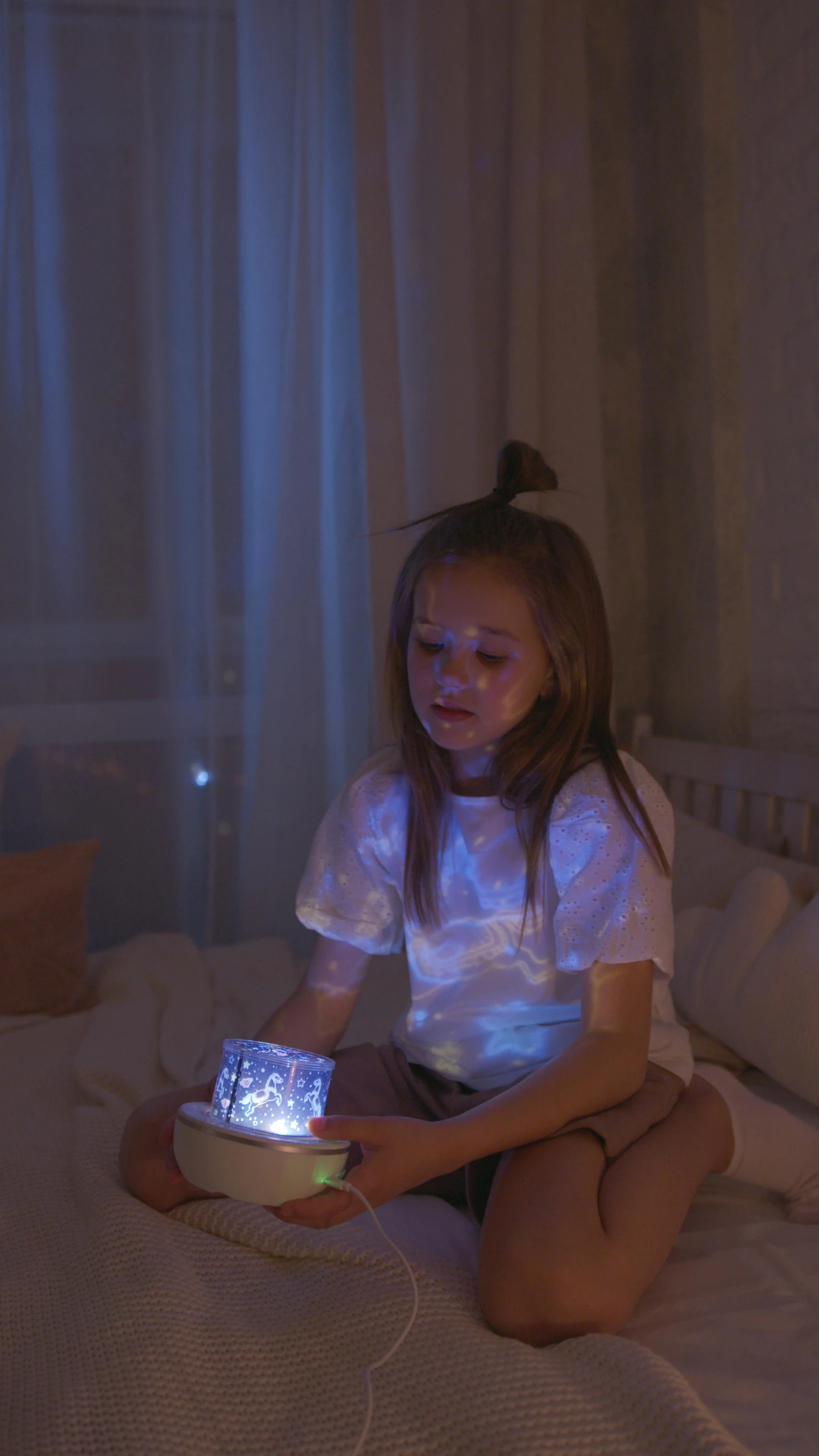 a little girl that is sitting on a bed, a hologram, pexels, lit. 'the cube', holding a candle holder, low quality photo, square