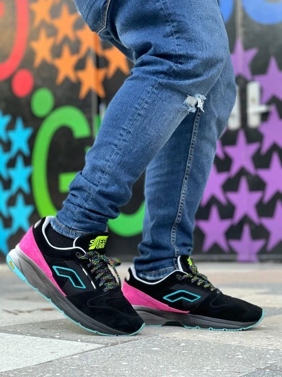 a person standing on a skateboard in front of a wall, an album cover, pexels contest winner, graffiti, ((neon colors)), running shoes, black blue green, high angle close up shot