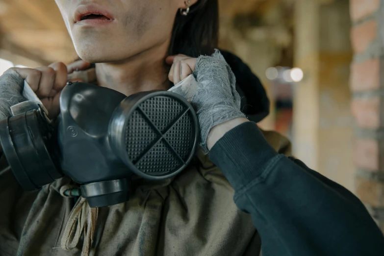 a woman wearing a gas mask and gloves, pexels contest winner, grenade in hand, instagram post, sweat and labour, wearing tactical gear