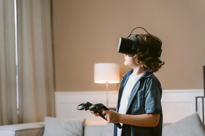 a young boy standing in a living room holding a video game controller, pexels, hypermodernism, floating vr headsets, avatar image, instagram picture