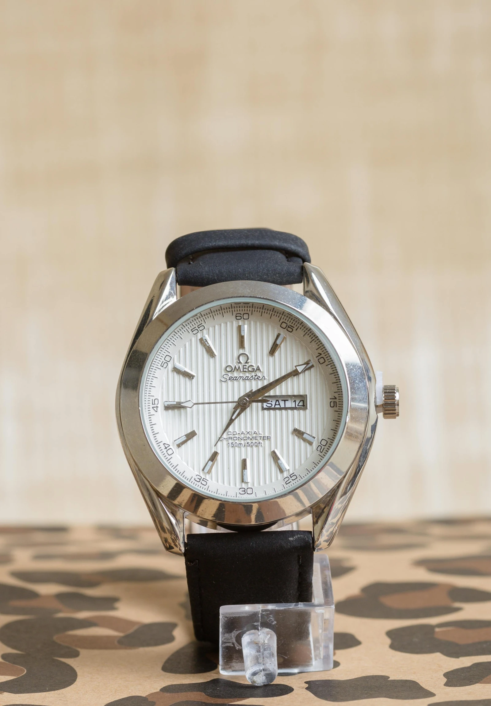 a close up of a watch on a table, inspired by Exekias, dau-al-set, white soft leather model, taken in the late 2000s, thumbnail, black and silver