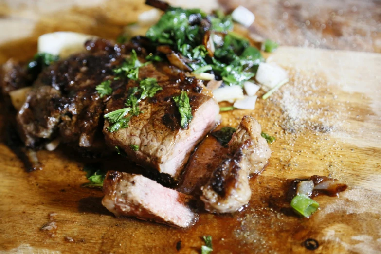 a piece of meat sitting on top of a wooden cutting board, by Niko Henrichon, unsplash, recipe, basil, steak, glazed