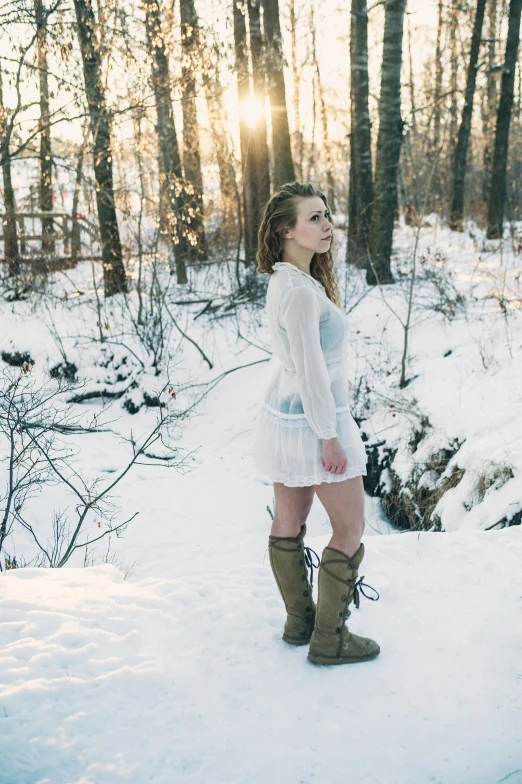 a woman standing on top of a snow covered ground, white blouse and gothic boots, sydney sweeney, facing the woods, 5 0 0 px models