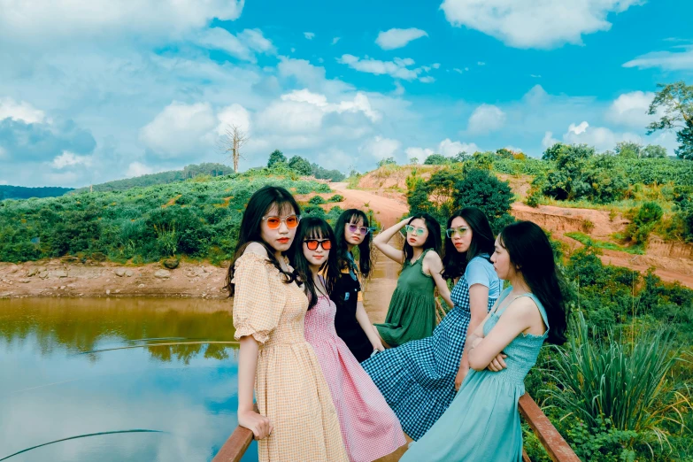 a group of women standing next to each other near a body of water, an album cover, by Tan Ting-pho, pexels contest winner, aestheticism, fairycore, ulzzang, on a green hill, ruan cute vtuber